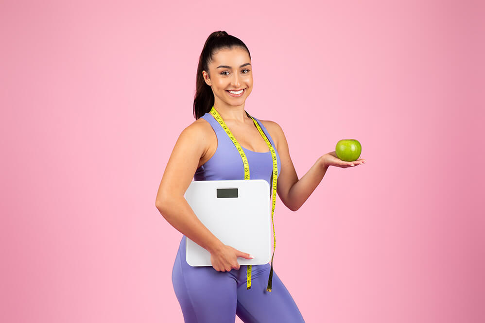 fitness-woman-with-scale-and-apple-2025-03-18-18-57-48-utc(1)