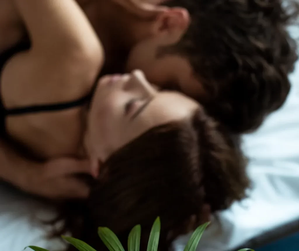 selective focus of plant near man and woman in bed utc