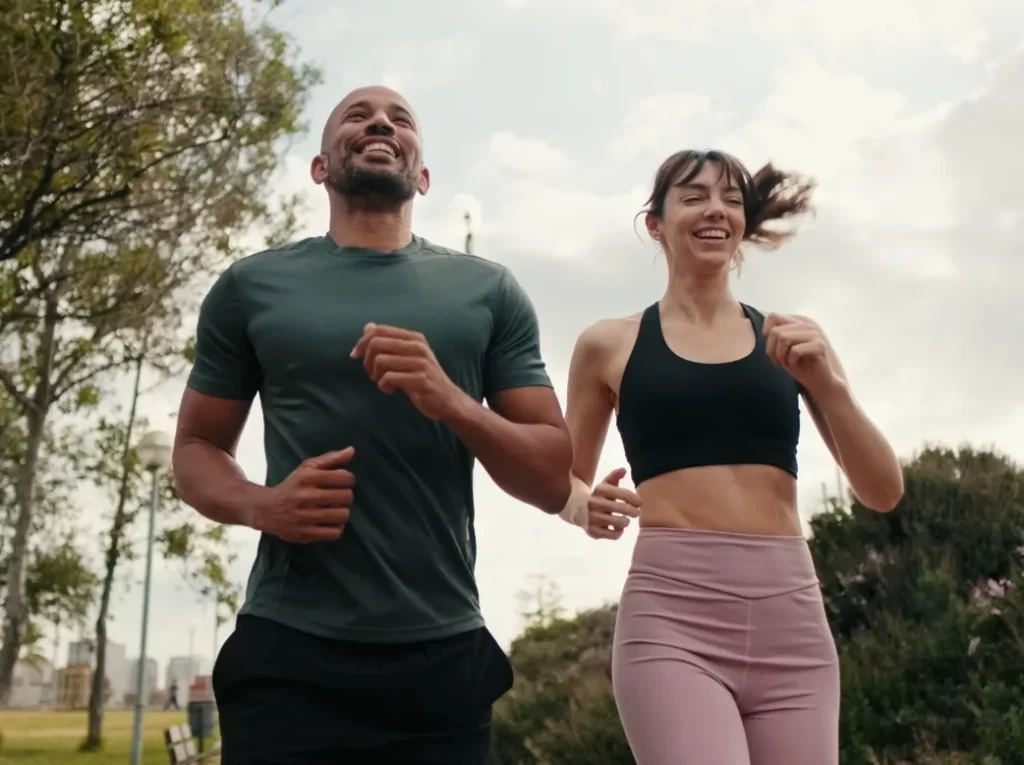 young joyful active couple jogging together in the utc